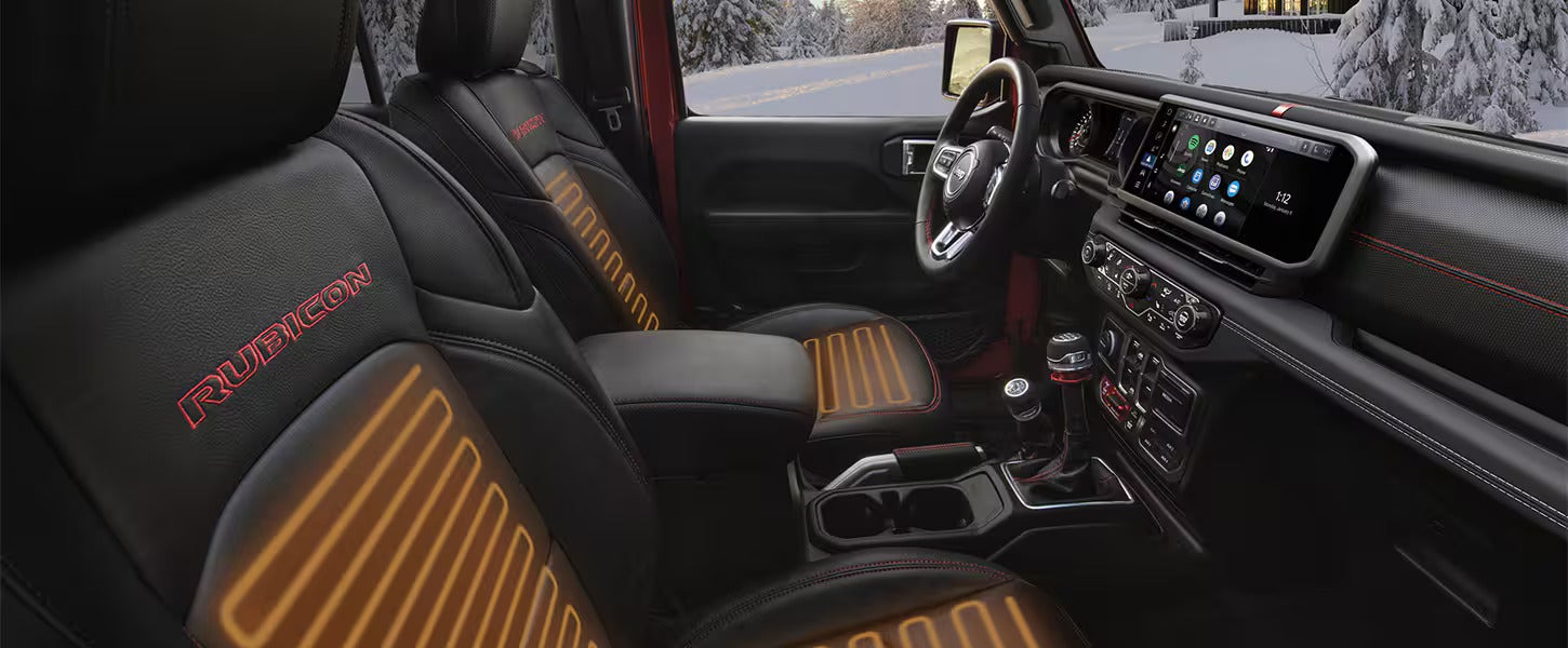 the front interior of a jeep wrangler showing heated driver and front passenger seats on the rubicon trim level