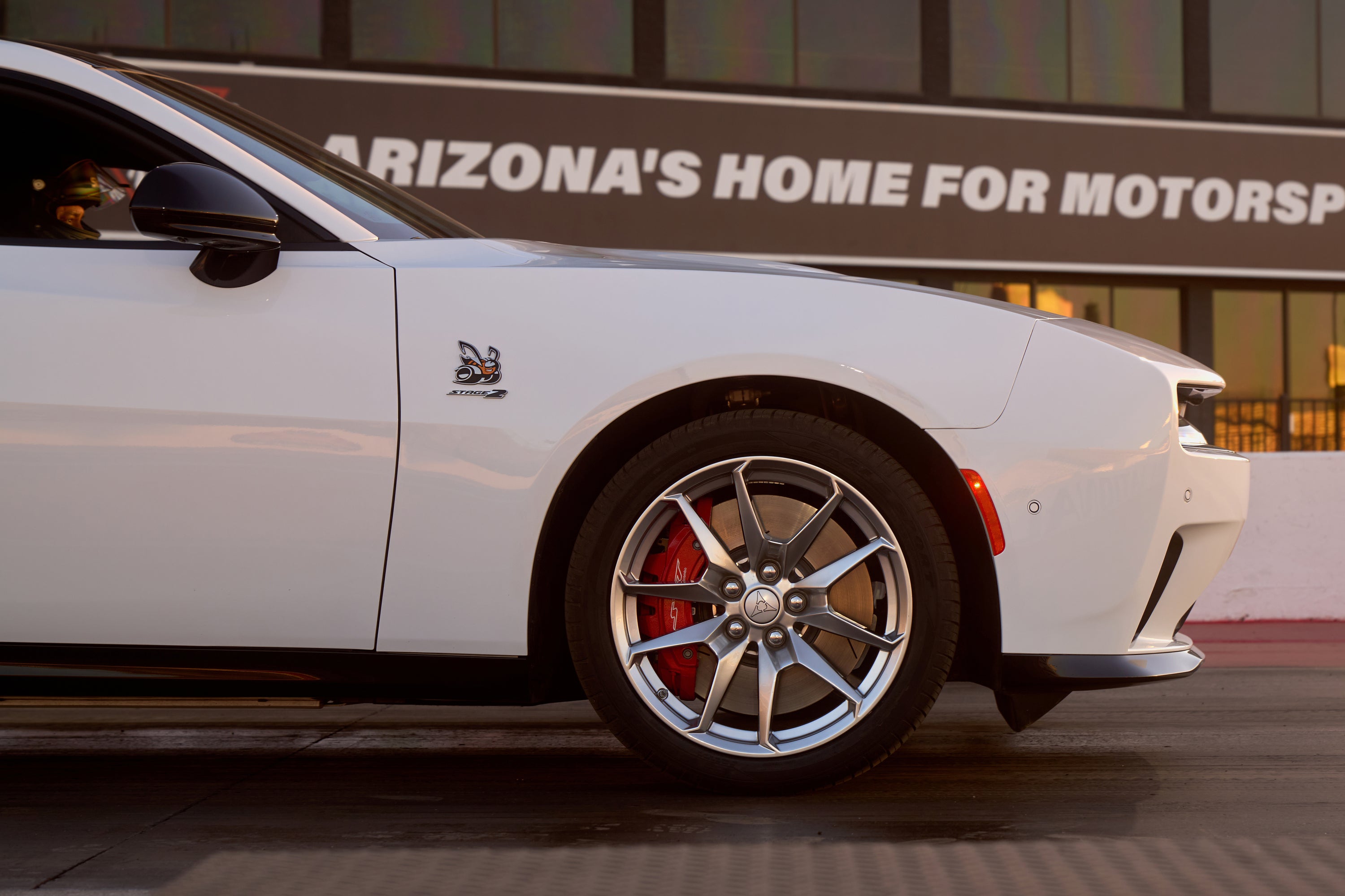 A white car sitting on a track.