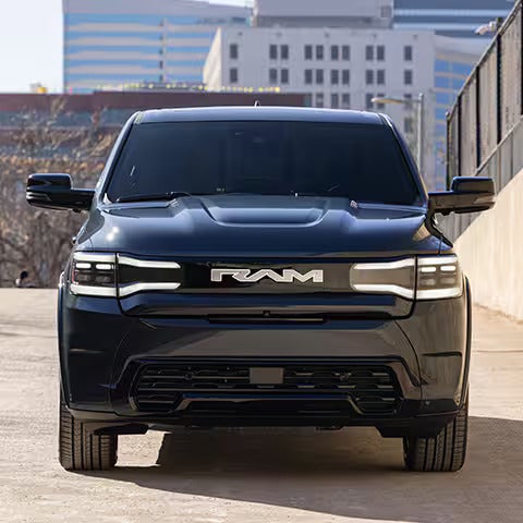 Front view of the 2025 Ram 1500 REV with LED headlights and the bold Ram logo, giving a modern and powerful look.