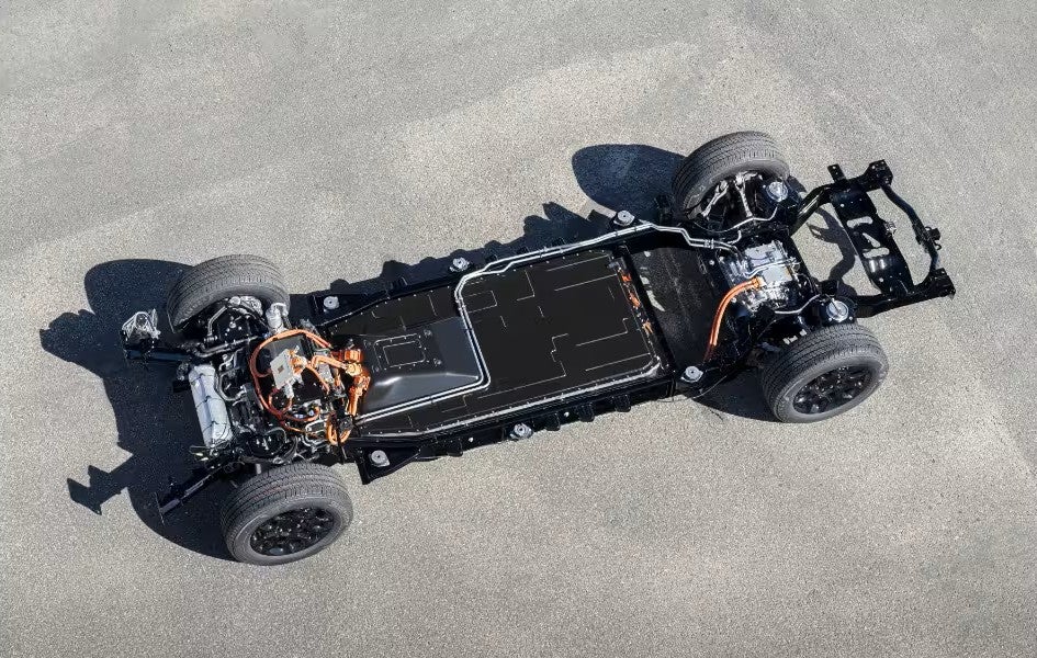 Underside view of the 2025 Ram 1500 REV's electric chassis, displaying battery placement and electric drivetrain components.